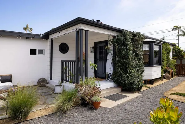 a front view of a house with garden