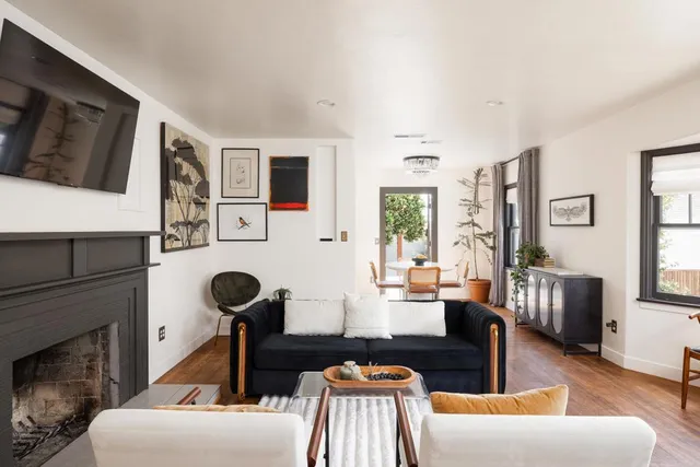 a living room with furniture fireplace and flat screen tv