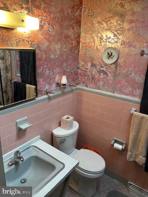 1424 Faunce Street Philadelphia, PA 19111 - Photo 16 of 19 a bathroom with a toilet a sink and mirror