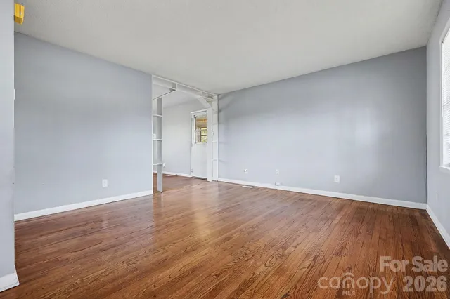 a view of an empty room and wooden floor
