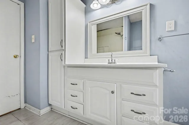 a bathroom with mirror cabinets and a sink