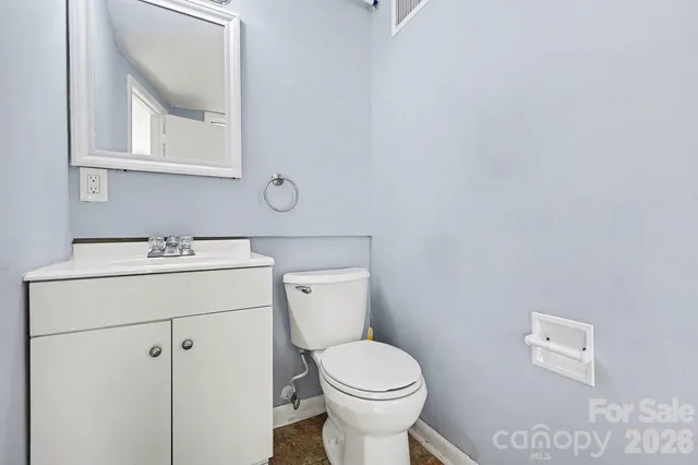 a white toilet sitting next to a bathroom sink