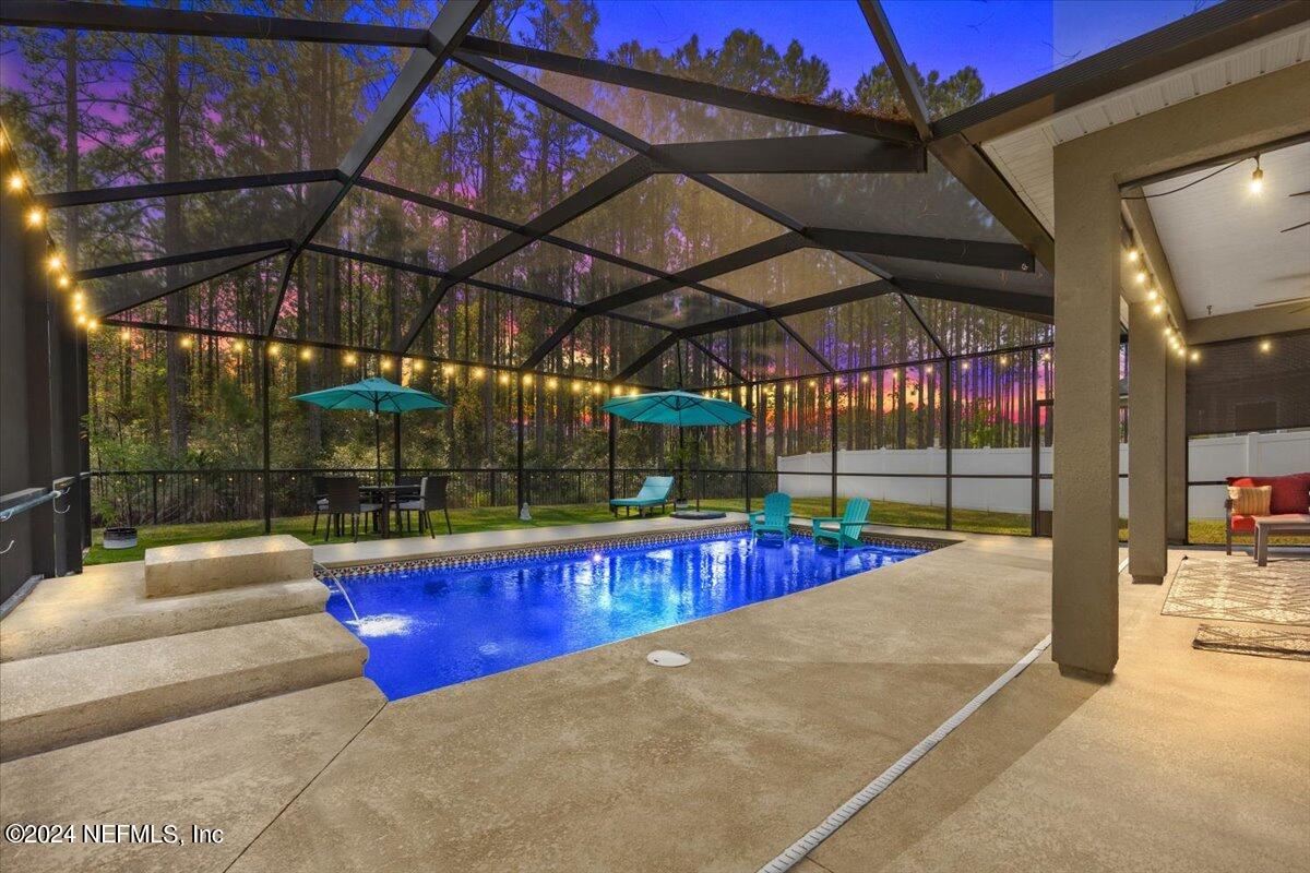 a view of a indoor swimming pool with a patio