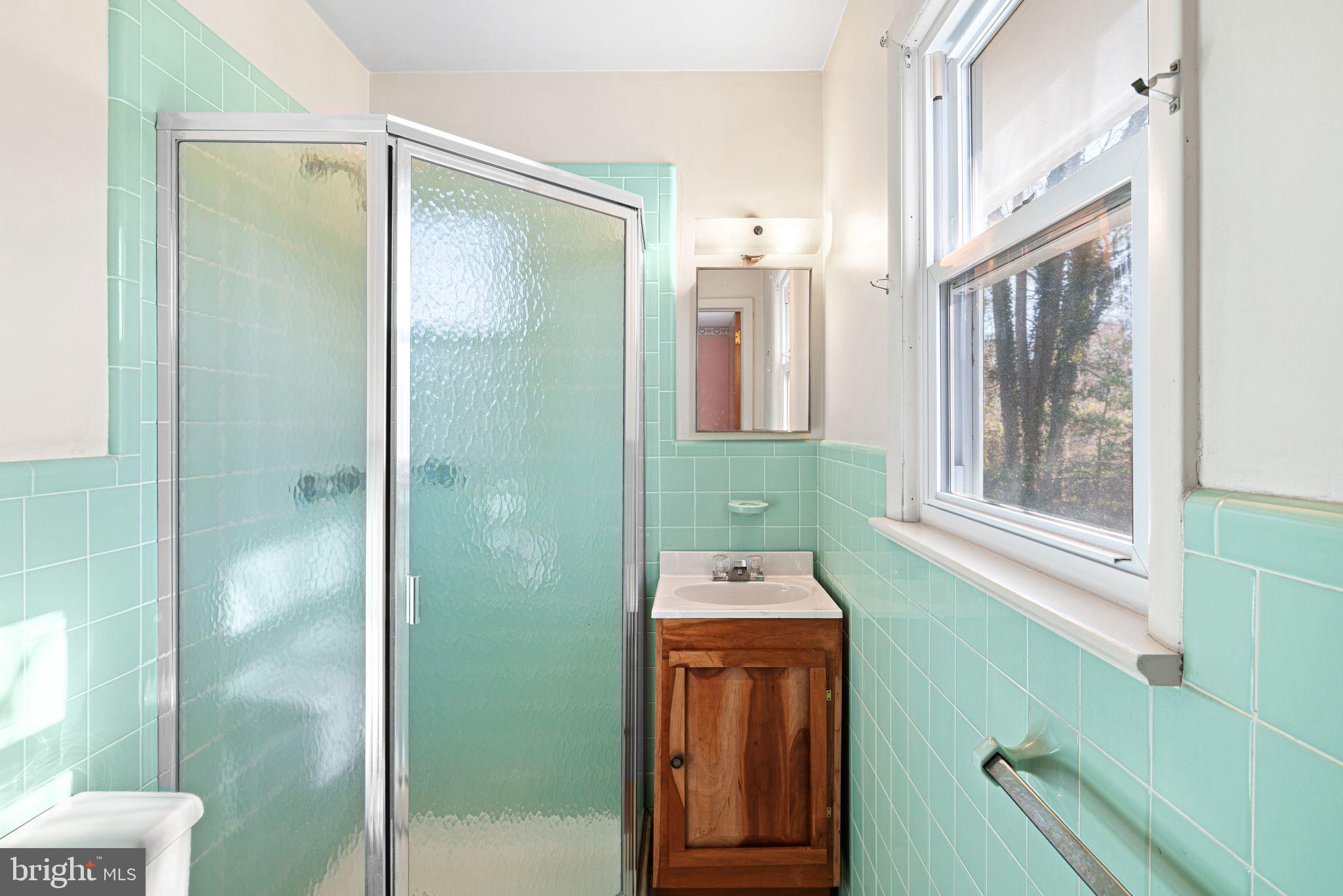 204 Linden Avenue Pitman, NJ 08071 - Photo 12 of 15 a bathroom with a shower sink and mirror