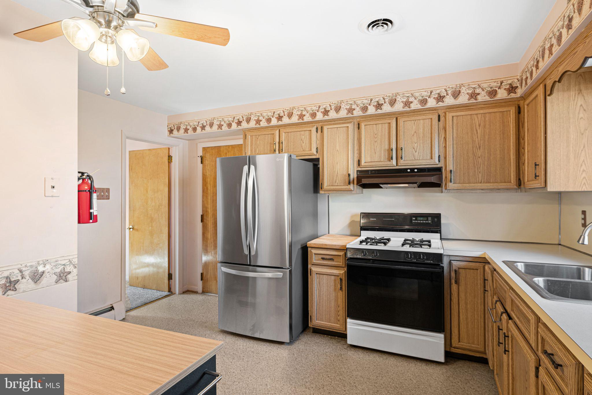 204 Linden Avenue Pitman, NJ 08071 - Photo 7 of 15 a kitchen with stainless steel appliances a stove a refrigerator and cabinets