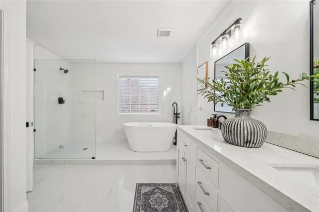 a bathroom with a sink a mirror and a bathtub