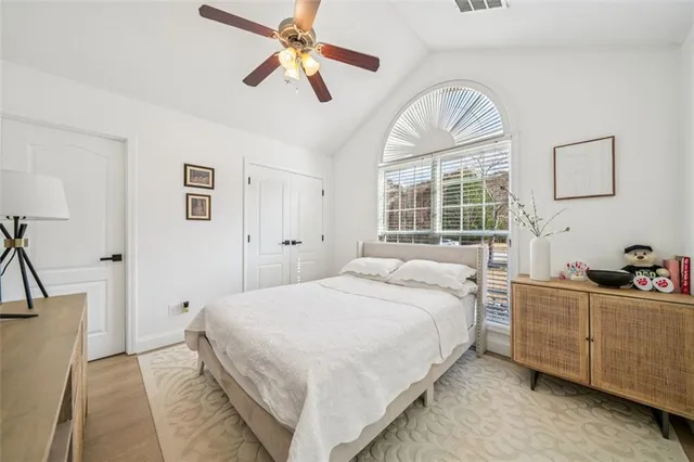 a bedroom with a large bed and a chandelier