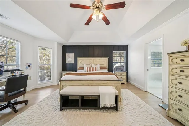 a bedroom with a bed and a view of dresser