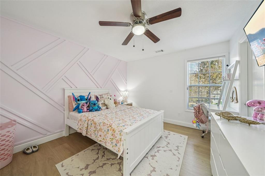 198 Celestial Run Winder, GA 30680 - Photo 19 of 30 a room with a bed and a chandelier