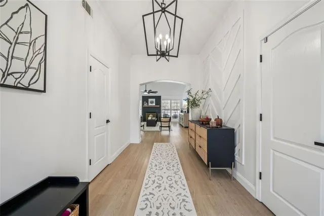 a view of a hallway with a livingroom and dining room