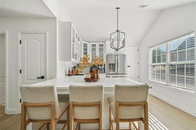 a dining room with furniture a chandelier and window