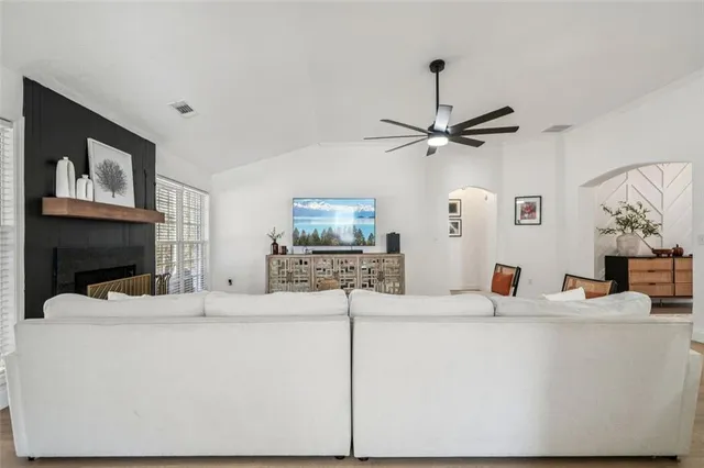 a living room with fireplace furniture and a flat screen tv