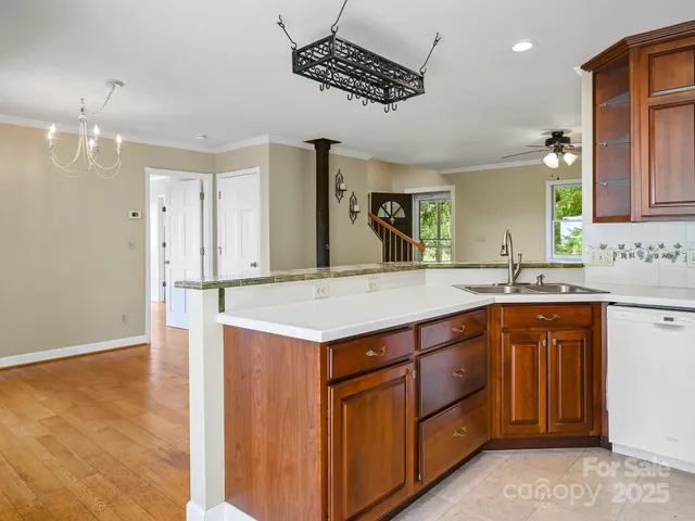 a kitchen with stainless steel appliances granite countertop a sink and a refrigerator