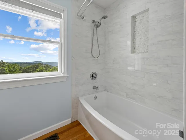 a bathroom with a bath tub and a shower