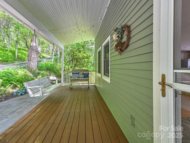 a view of balcony with wooden floor and outdoor seating