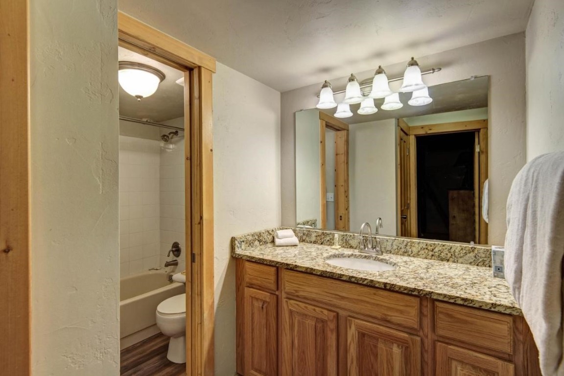 325 Four Oclock Road, Unit A101 Breckenridge, CO 80424 - Photo 15 of 16 a bathroom with a granite countertop sink toilet and shower
