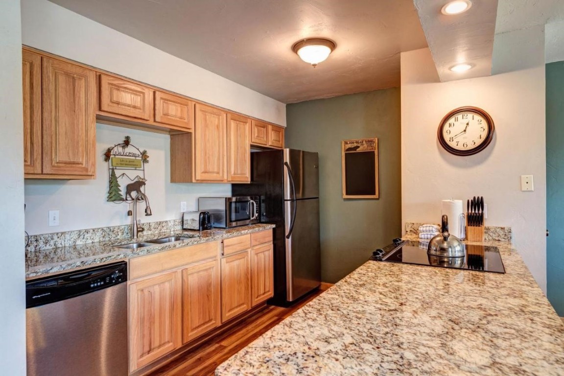 325 Four Oclock Road, Unit A101 Breckenridge, CO 80424 - Photo 5 of 16 a kitchen with a refrigerator and a sink