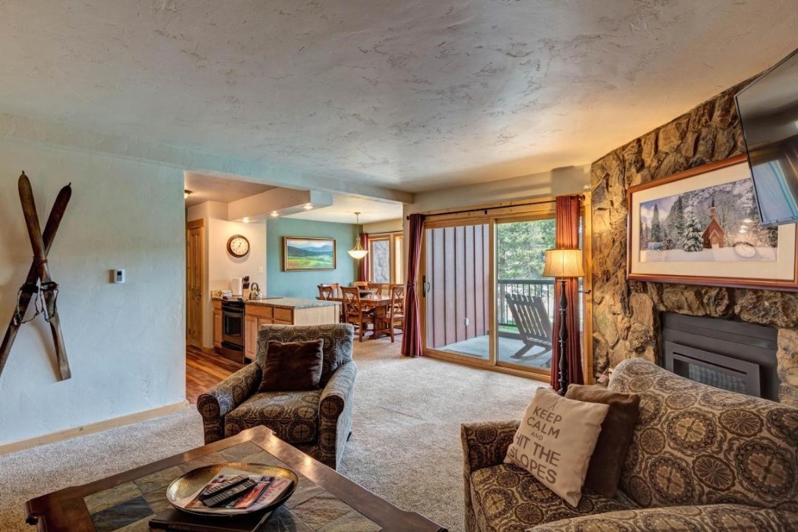 325 Four Oclock Road, Unit A101 Breckenridge, CO 80424 - Photo 7 of 16 a living room with furniture and a fireplace