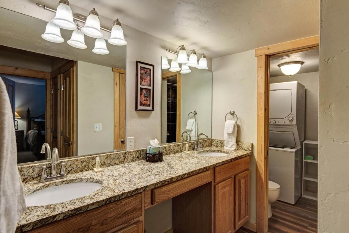 325 Four Oclock Road, Unit A101 Breckenridge, CO 80424 - Photo 9 of 16 a bathroom with a granite countertop double vanity sink and a mirror