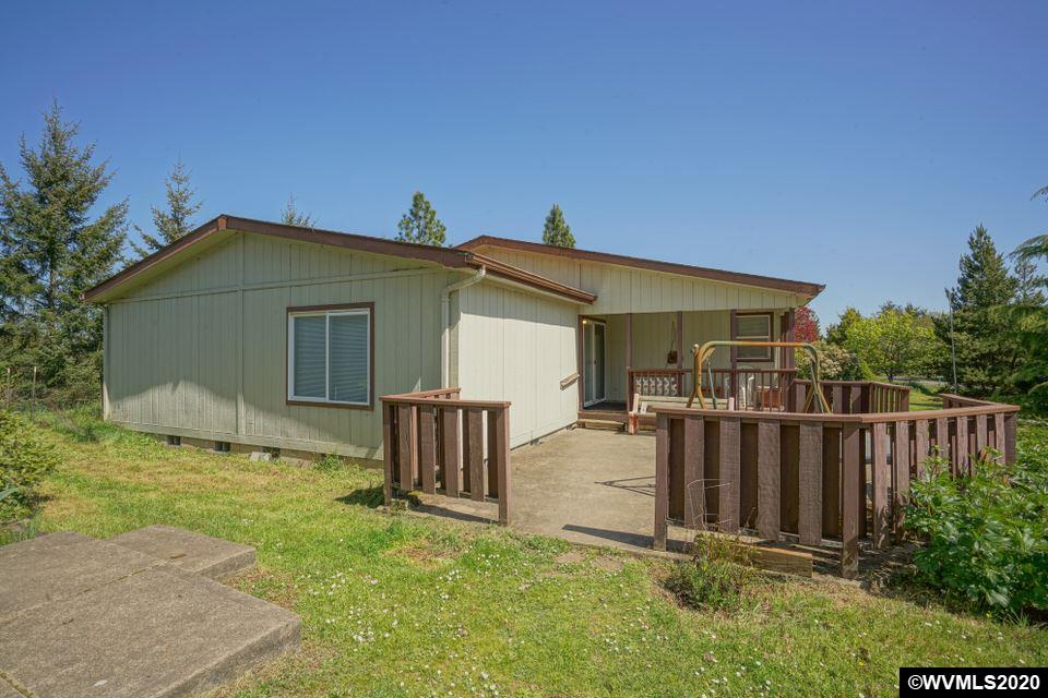 17265 Butler Hill Road Dallas, OR 97338 - Photo 4 of 38 a backyard of a house with table and chairs