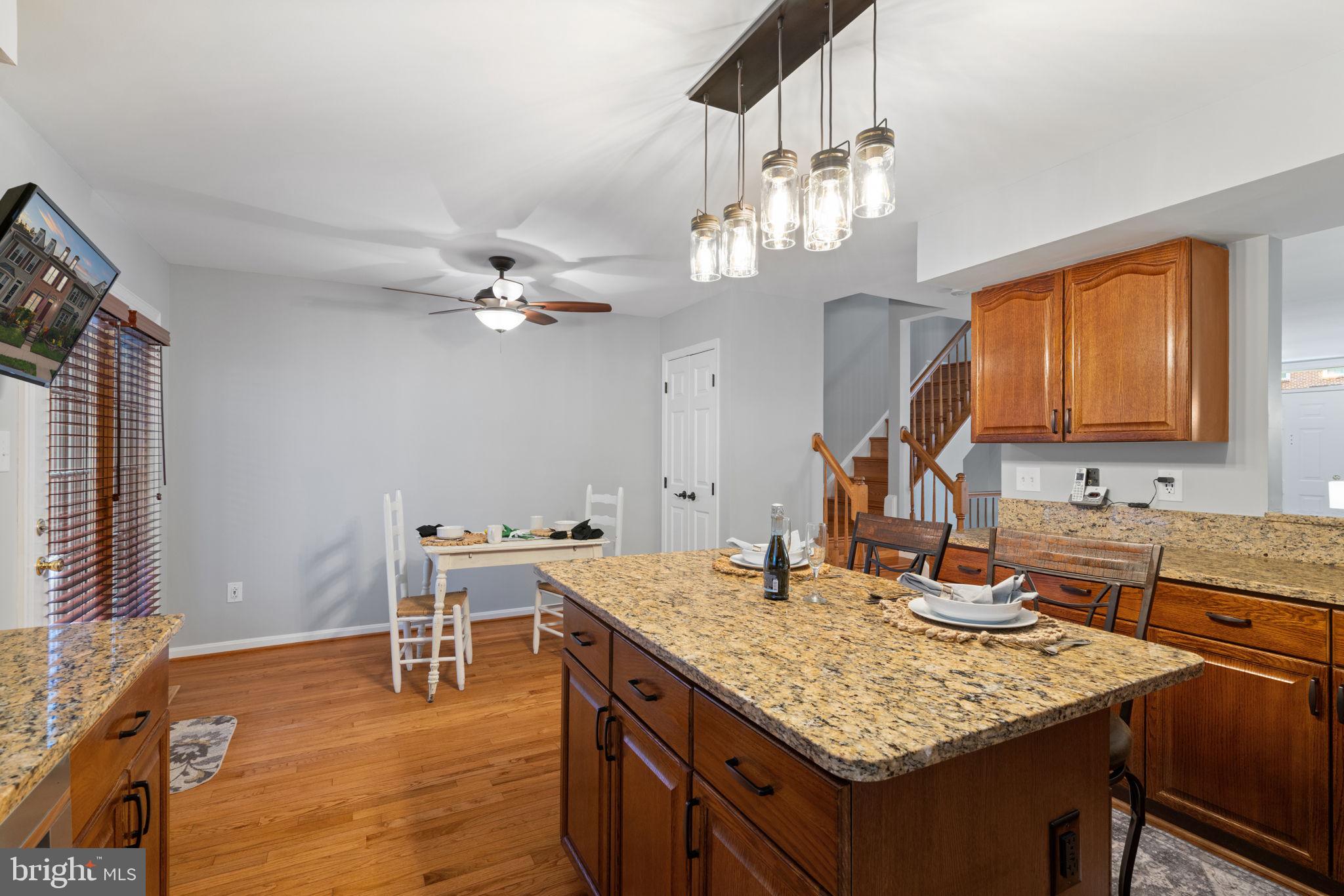 8852 Eagle Rock Lane Springfield, VA 22153 - Photo 13 of 61 a kitchen with a counter space dining table and chairs