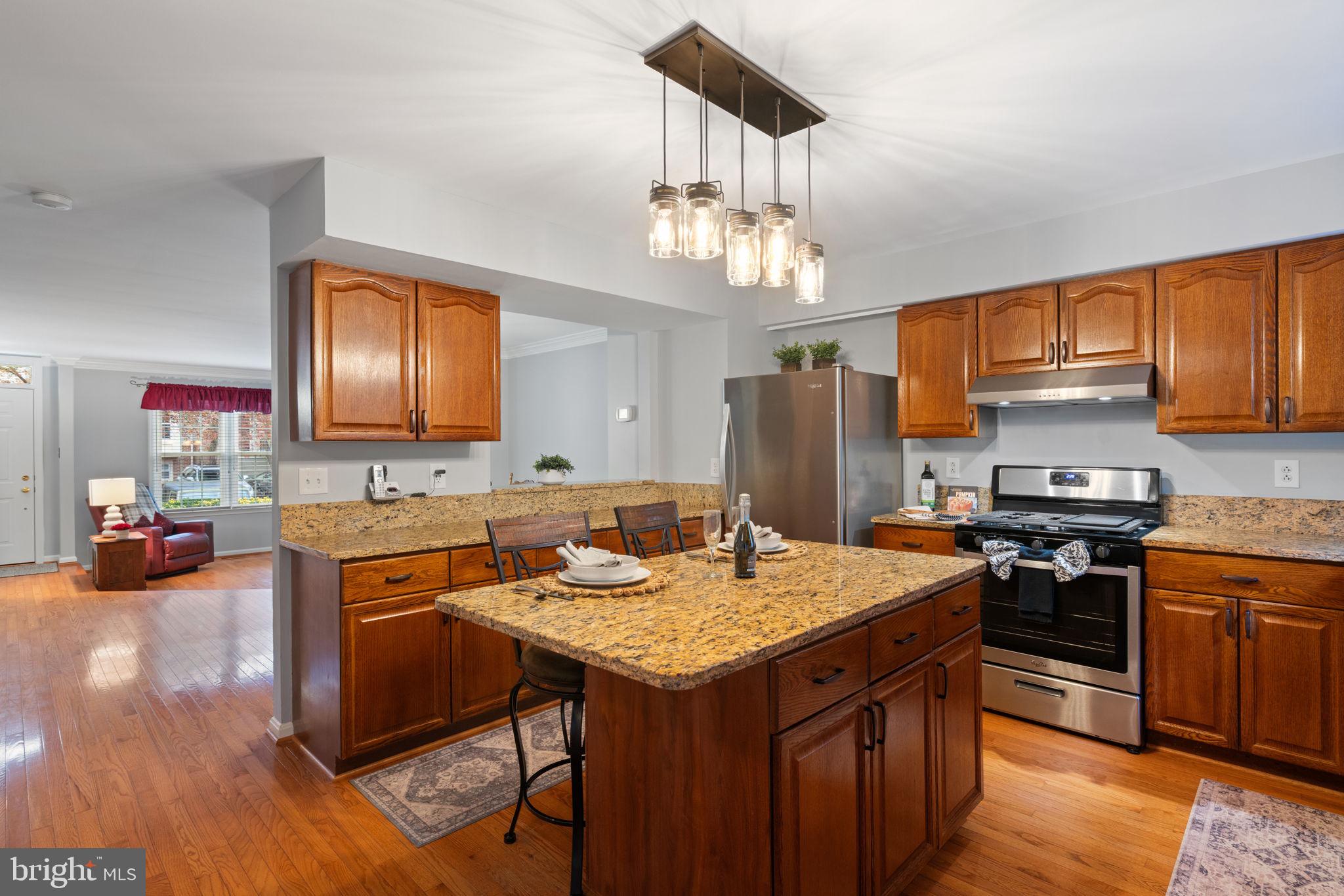 8852 Eagle Rock Lane Springfield, VA 22153 - Photo 14 of 61 a kitchen with a stove and a refrigerator