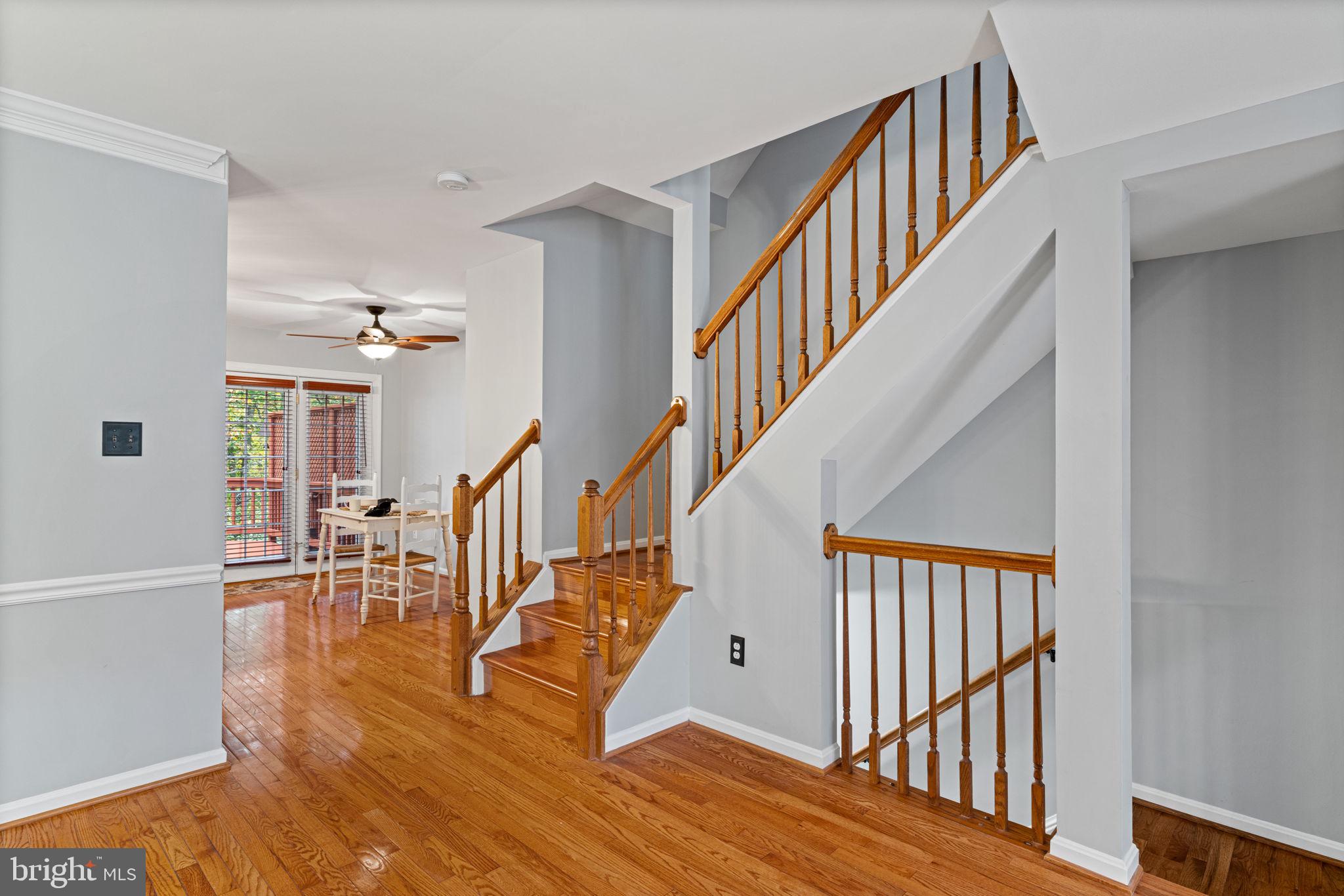 8852 Eagle Rock Lane Springfield, VA 22153 - Photo 16 of 61 a view of staircase with lots of frames on wall and wooden floor