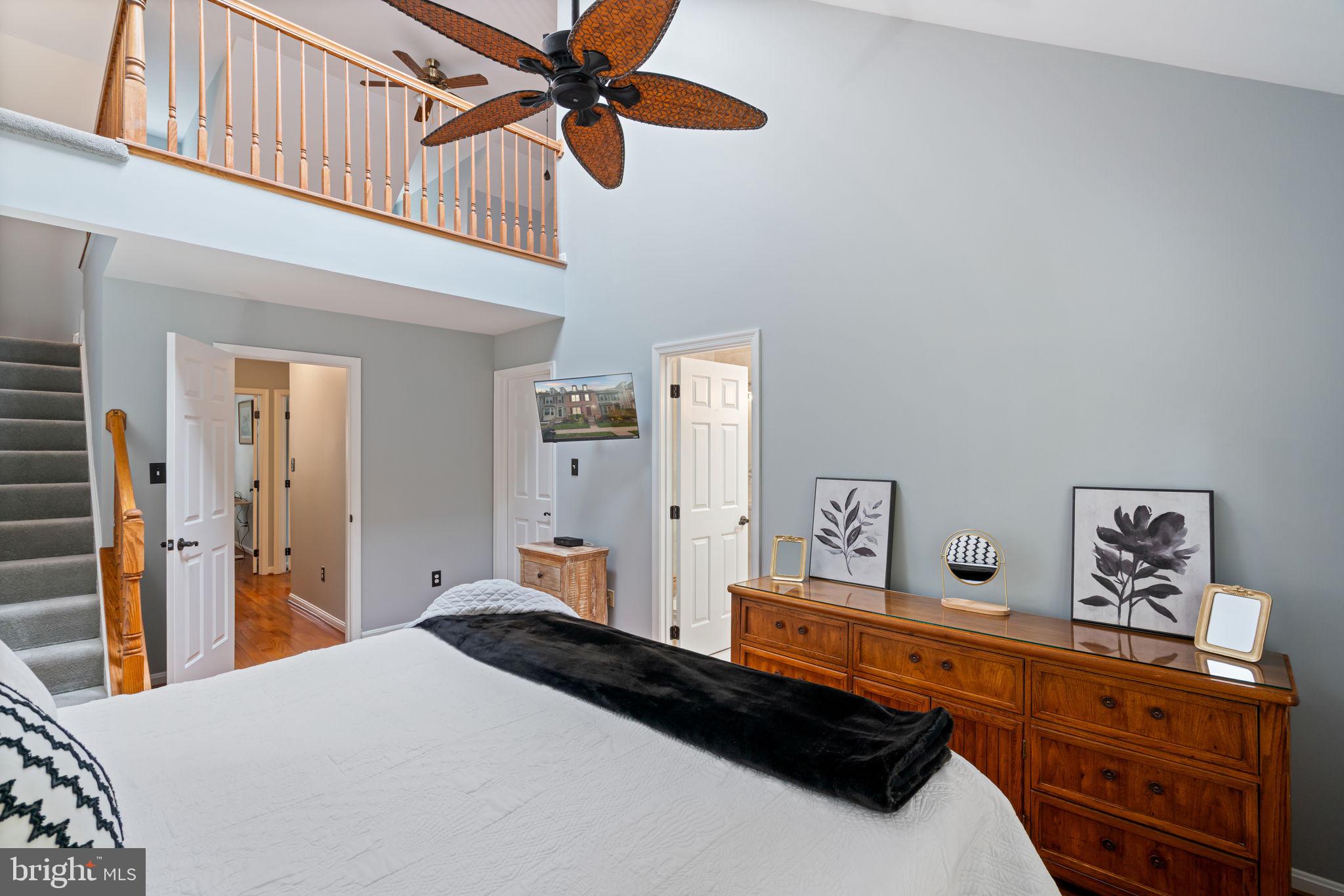 8852 Eagle Rock Lane Springfield, VA 22153 - Photo 20 of 61 a bedroom with a bed and a chandelier