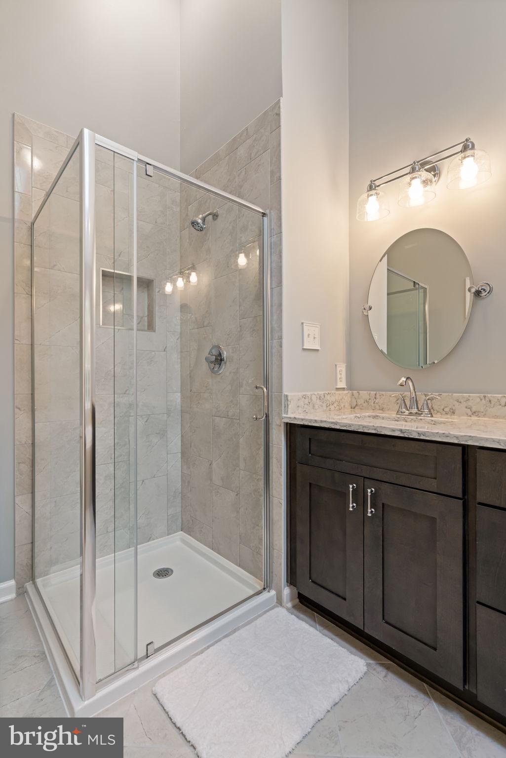 8852 Eagle Rock Lane Springfield, VA 22153 - Photo 23 of 61 a bathroom with a double vanity sink mirror and shower