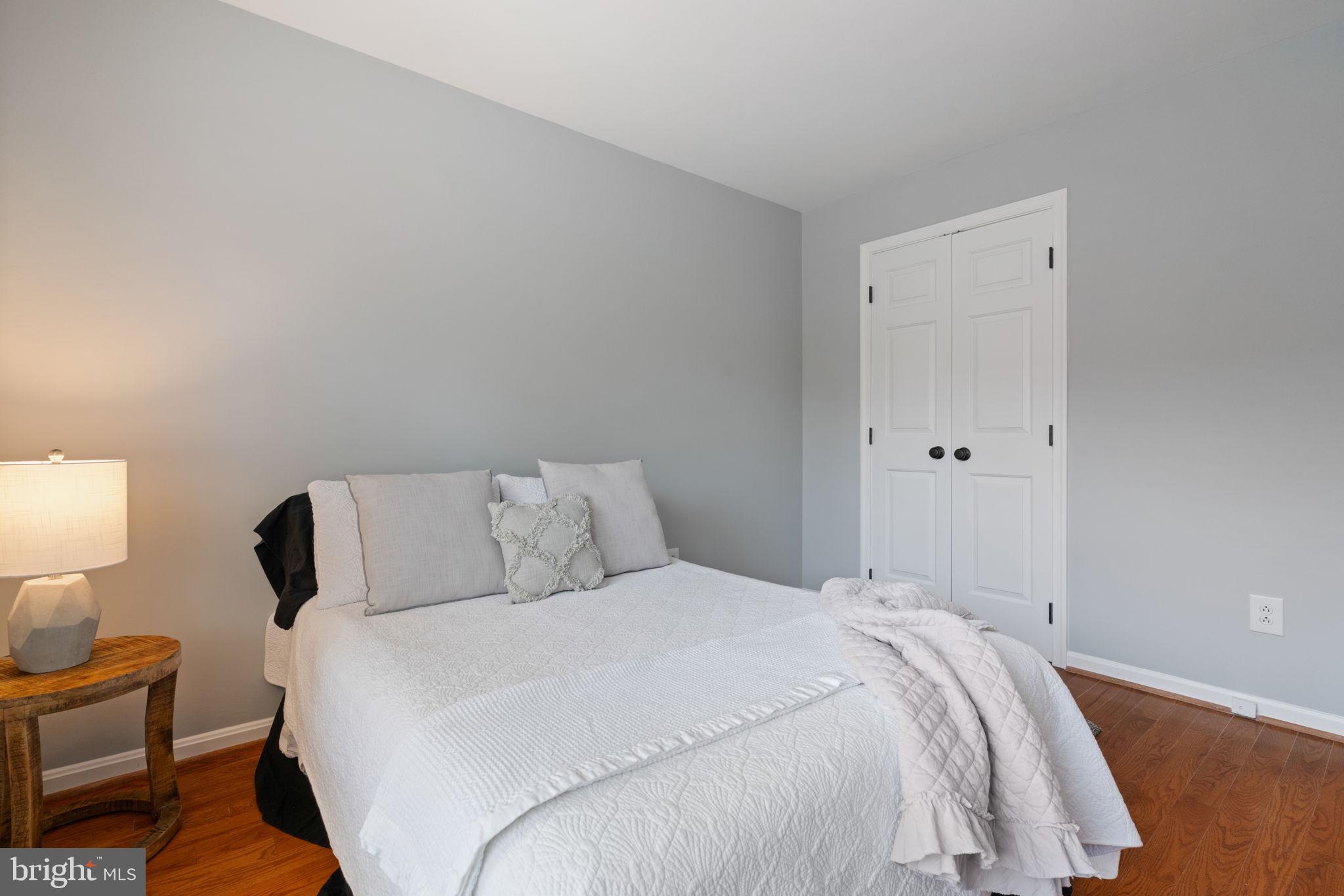 8852 Eagle Rock Lane Springfield, VA 22153 - Photo 26 of 61 a bedroom with a bed and a lamp