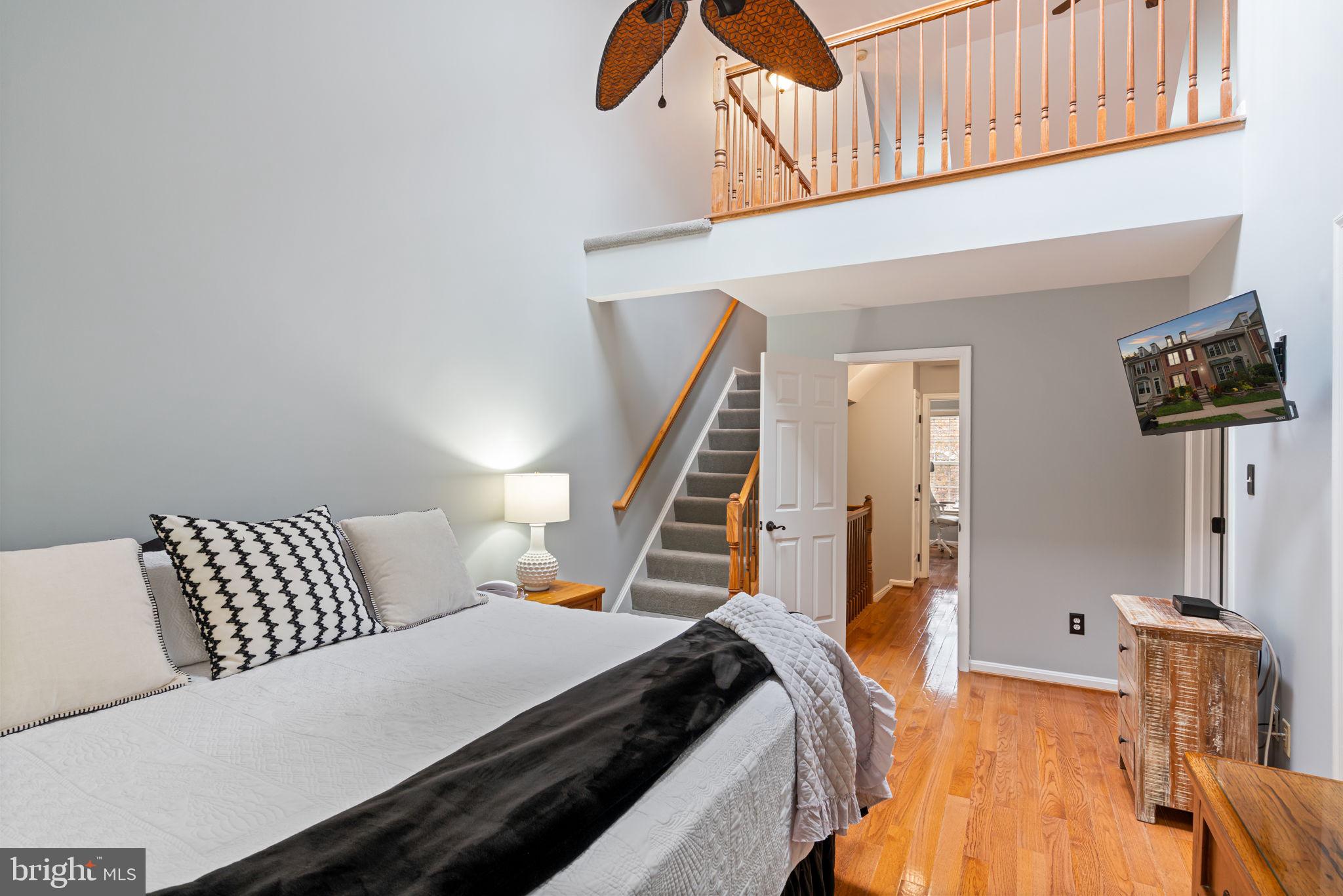 8852 Eagle Rock Lane Springfield, VA 22153 - Photo 32 of 61 a bedroom with a bed and wooden floor