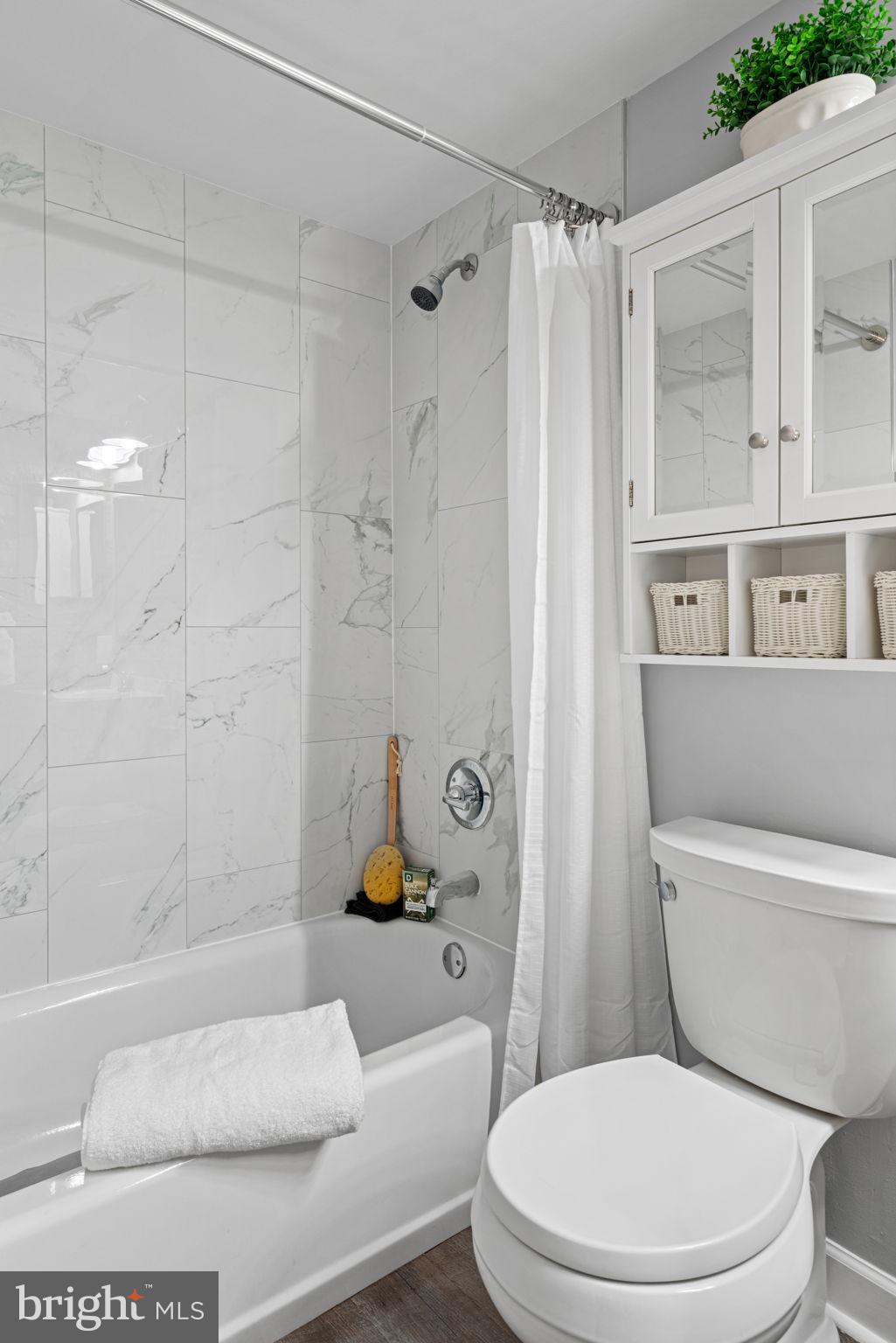 8852 Eagle Rock Lane Springfield, VA 22153 - Photo 40 of 61 a white toilet sitting next to a bath tub