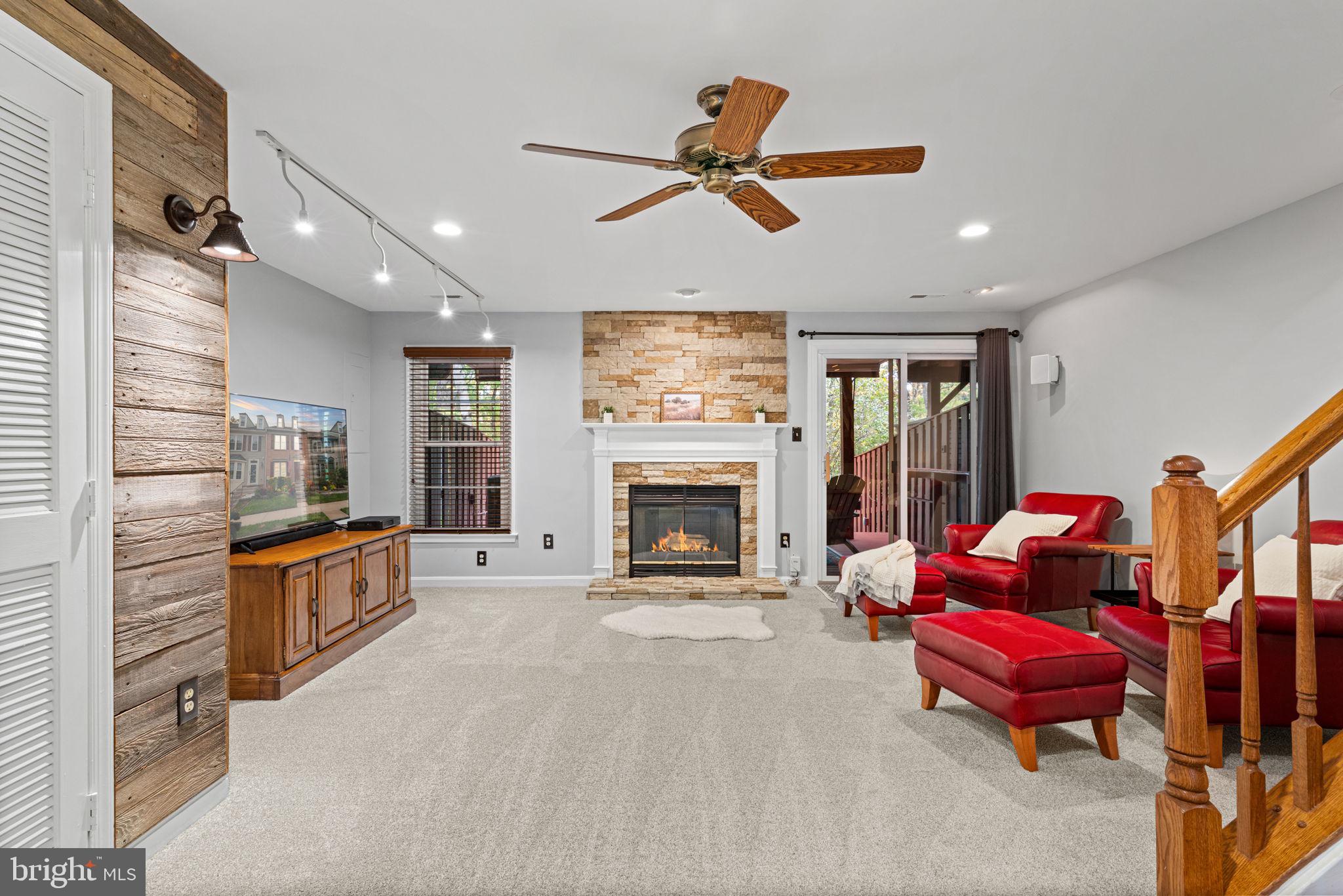 8852 Eagle Rock Lane Springfield, VA 22153 - Photo 41 of 61 a living room with furniture a fireplace and a chandelier