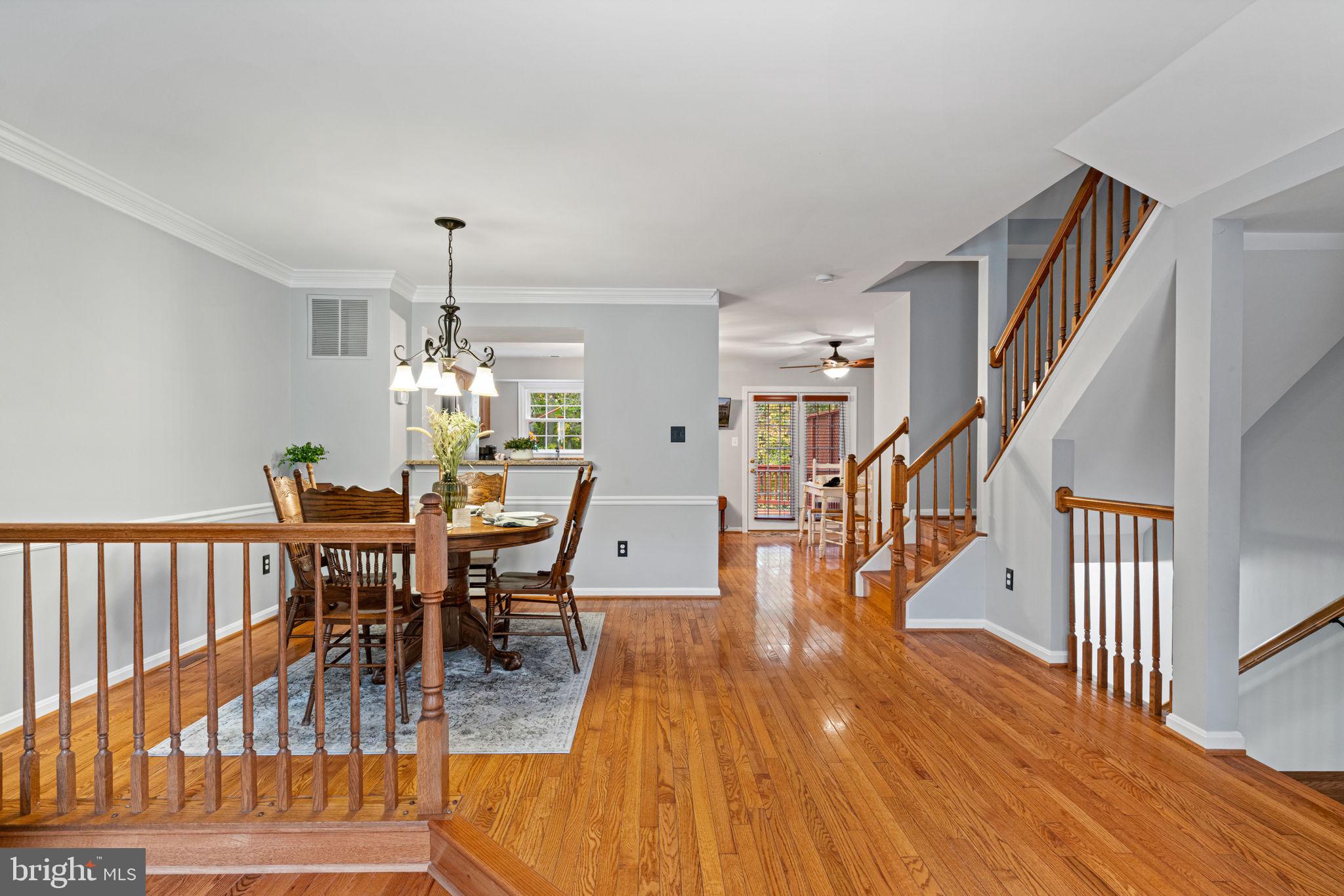 8852 Eagle Rock Lane Springfield, VA 22153 - Photo 7 of 61 a view of a dining room and hall with wooden floor