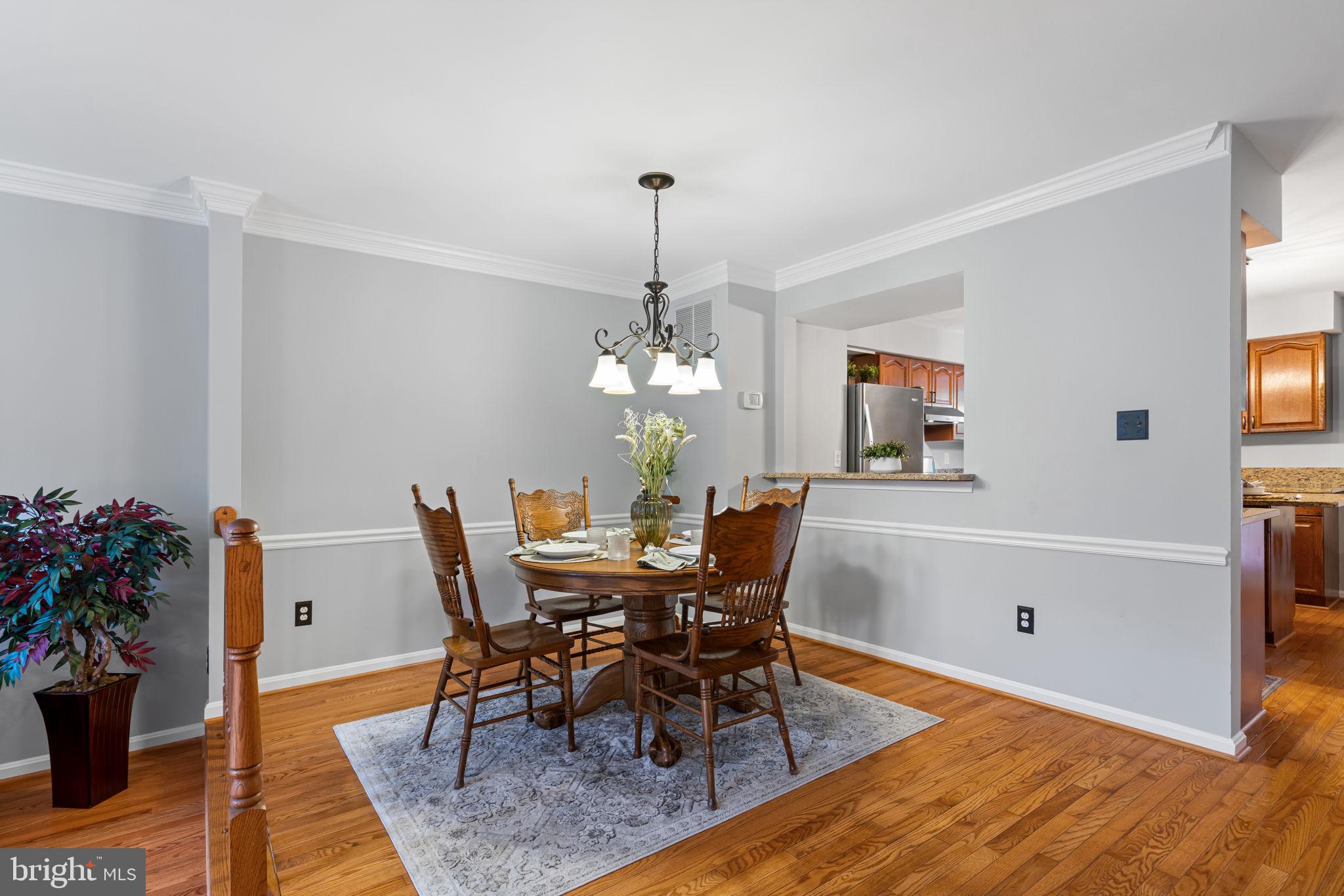 8852 Eagle Rock Lane Springfield, VA 22153 - Photo 8 of 61 a dining room with furniture potted plants and wooden floor