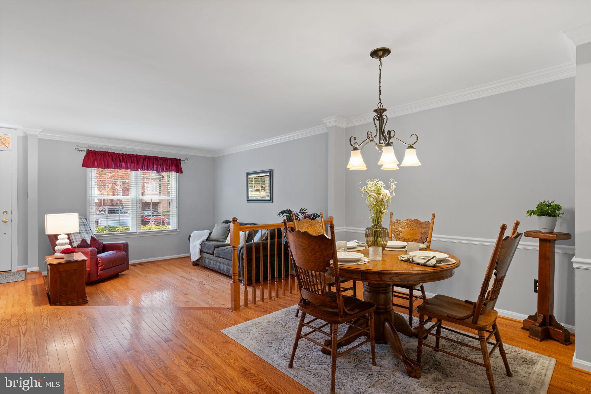 8852 Eagle Rock Lane Springfield, VA 22153 - Photo 9 of 61 a dining room with furniture a chandelier and wooden floor