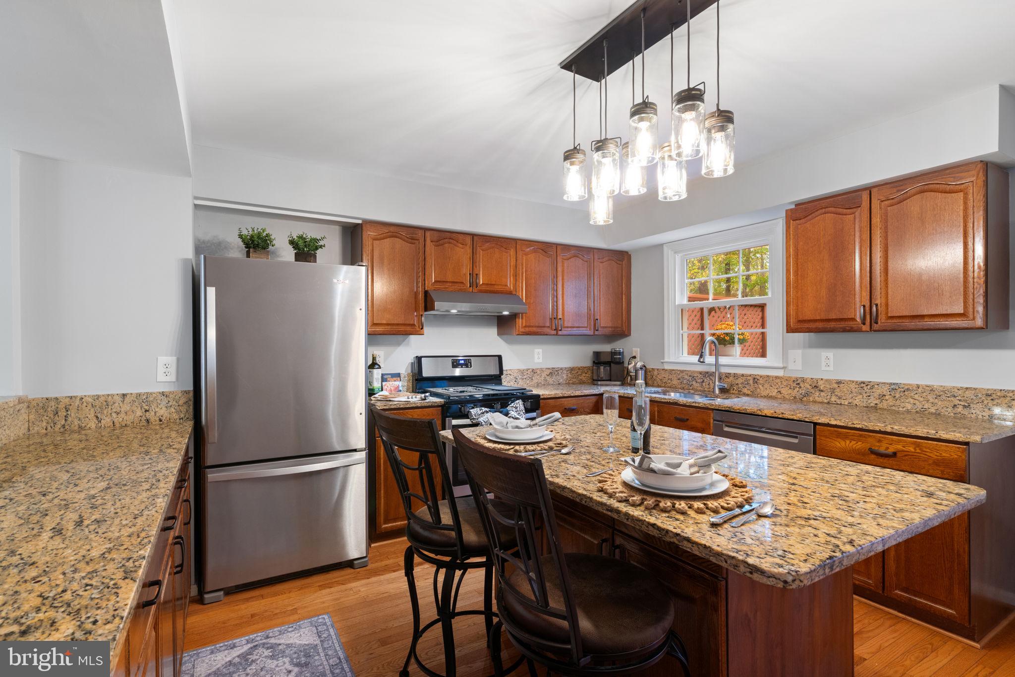 8852 Eagle Rock Lane Springfield, VA 22153 - Photo 10 of 61 a kitchen with stainless steel appliances granite countertop a sink stove and refrigerator