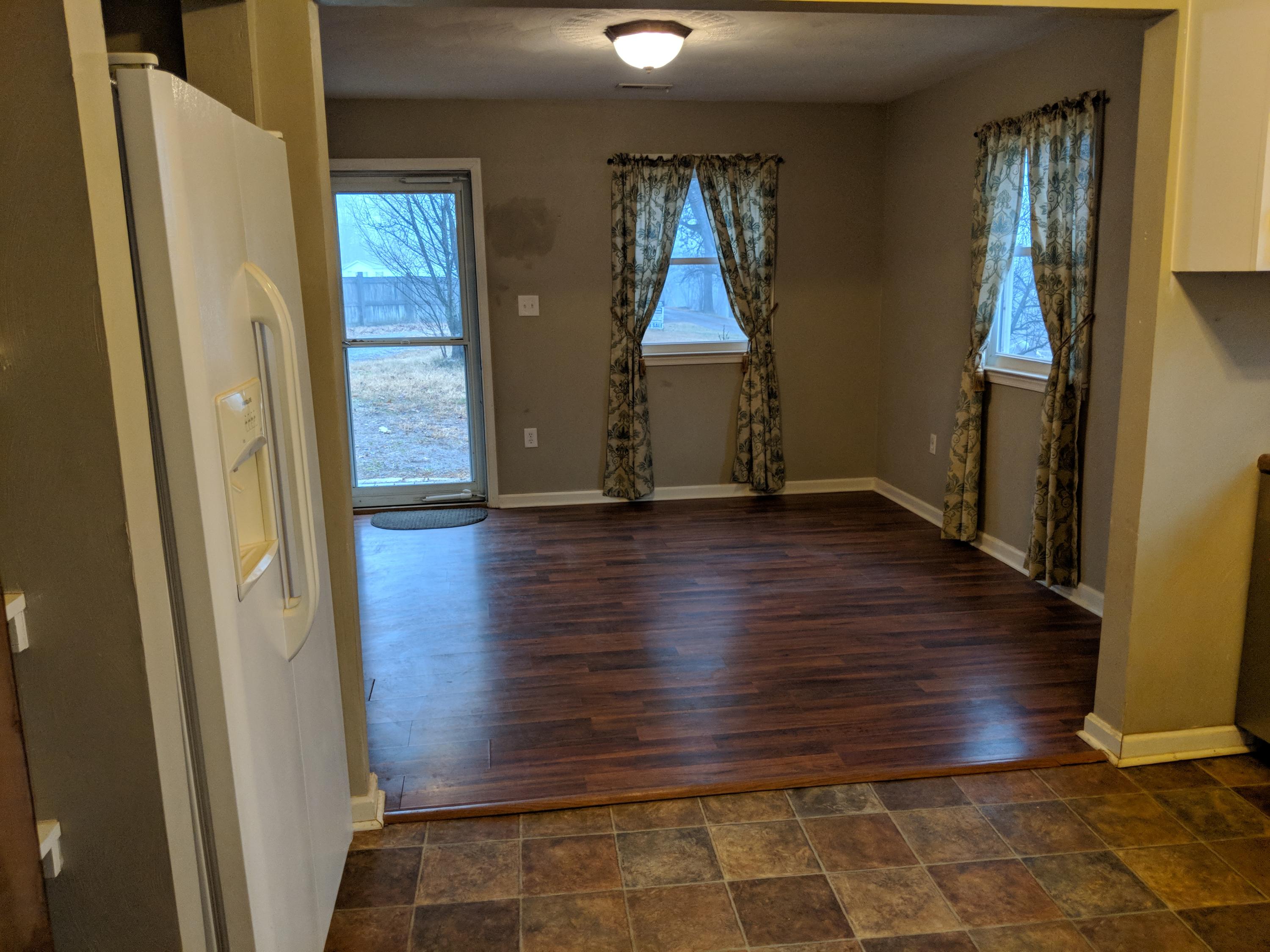 2902 Riverview Road Roanoke, VA 24014 - Photo 2 of 15 an empty room with wooden floor and windows