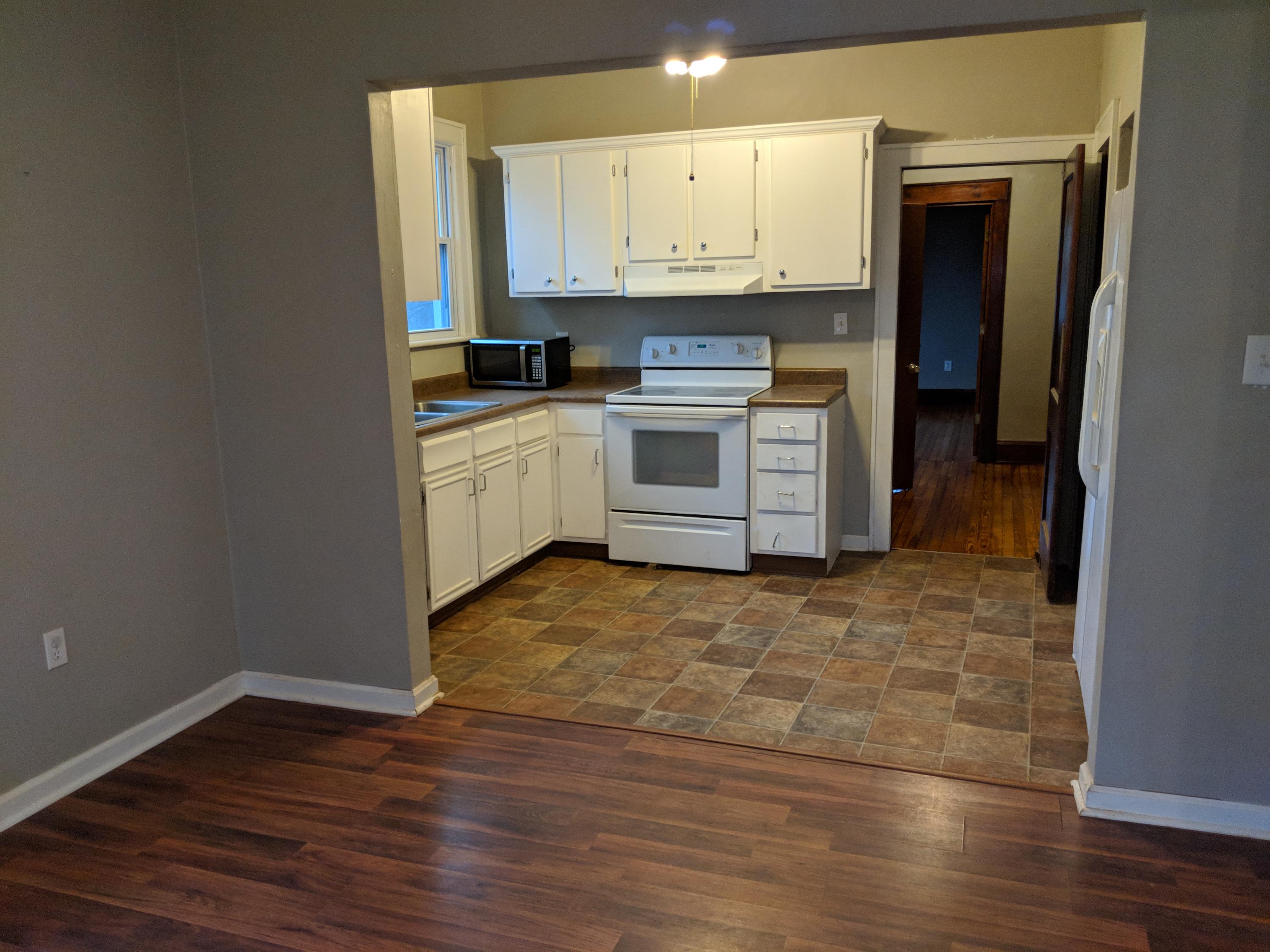 2902 Riverview Road Roanoke, VA 24014 - Photo 3 of 15 a kitchen with stainless steel appliances granite countertop a stove a sink and white cabinets