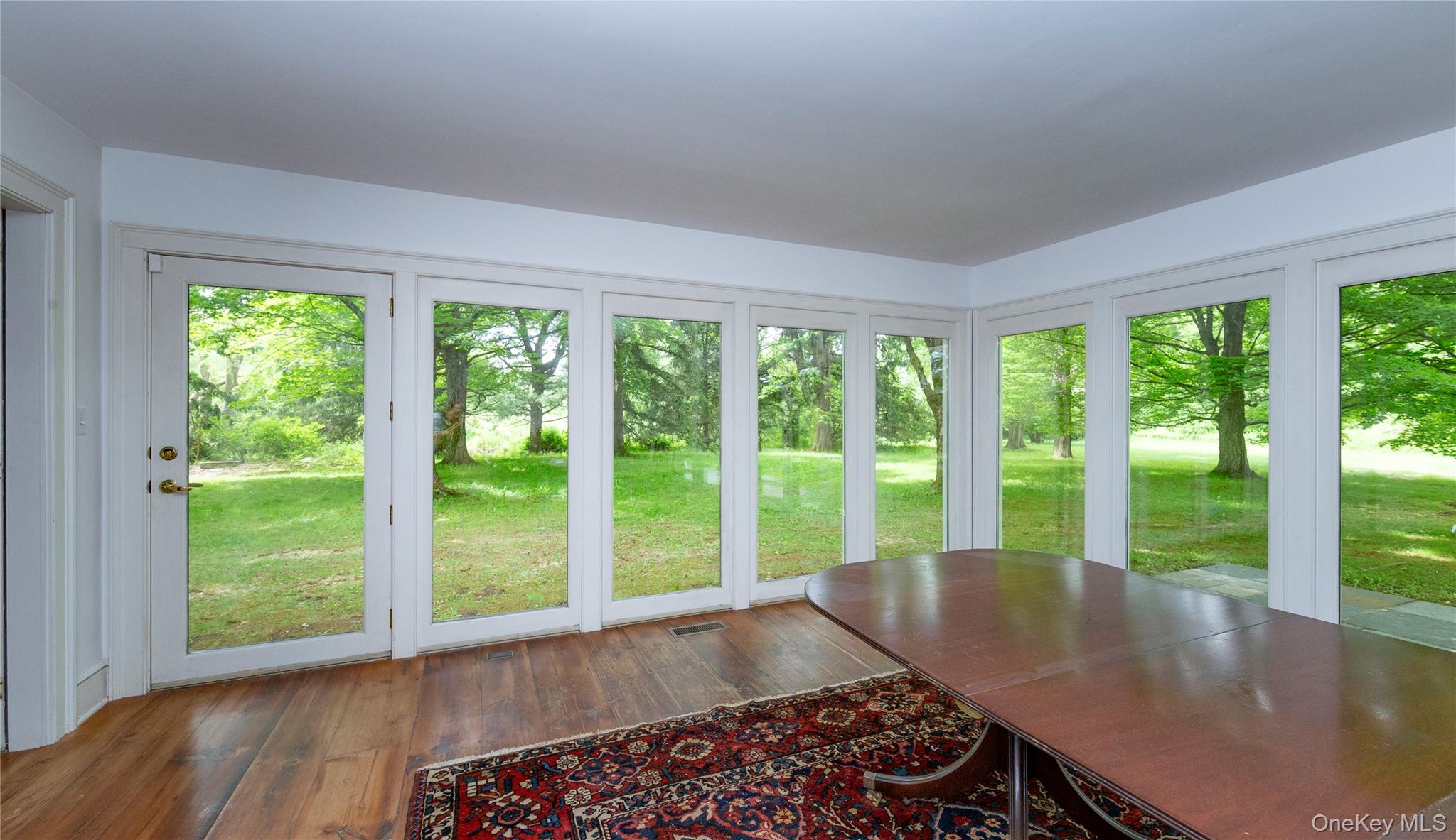 64 South Quaker Hill Road Pawling, NY 12564 - Photo 19 of 41 Room featuring wood-finish flooring and a series of floor-to-ceiling windows