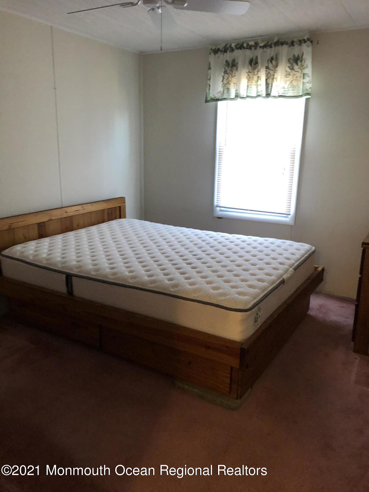 580 Cherin Road Freehold, NJ 07728 - Photo 16 of 23 a bed sitting in a bedroom next to a window