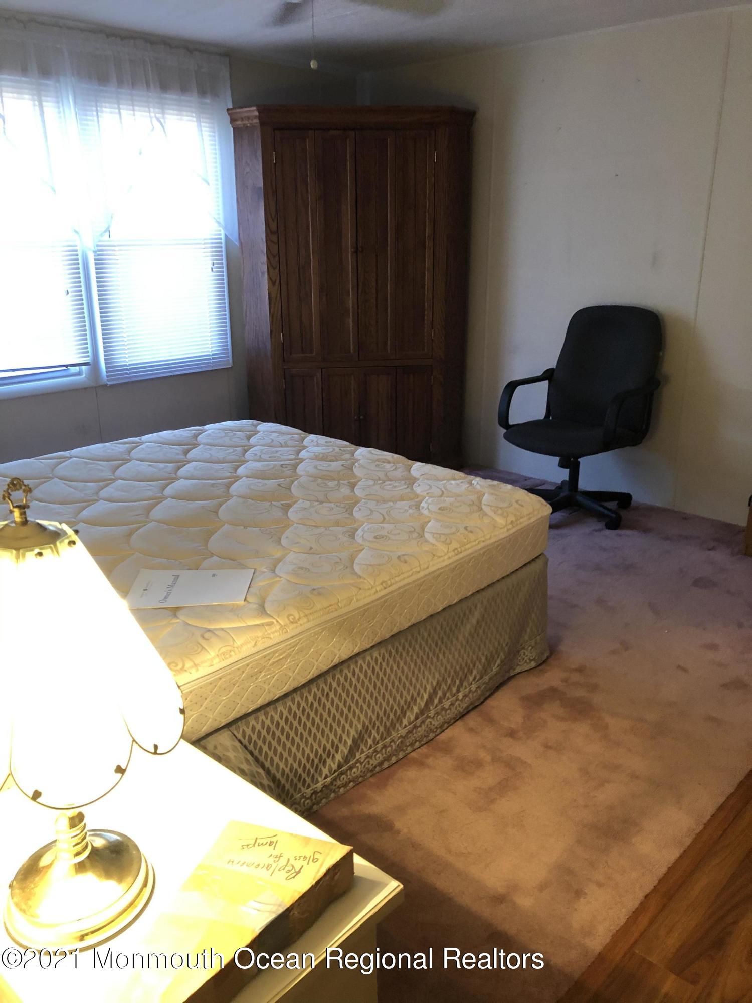 580 Cherin Road Freehold, NJ 07728 - Photo 19 of 23 a bedroom with a bed and a chair
