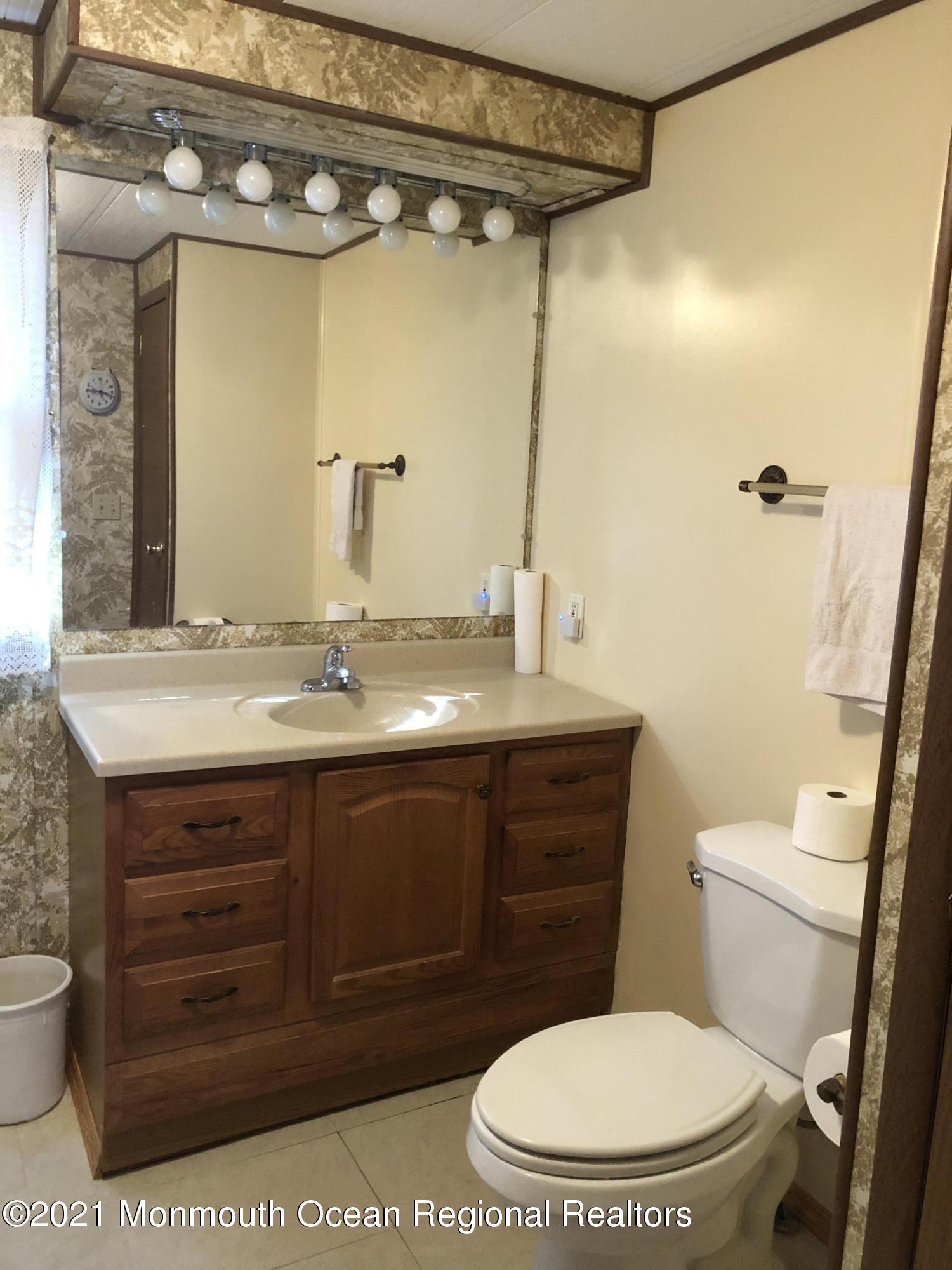 580 Cherin Road Freehold, NJ 07728 - Photo 21 of 23 a bathroom with a granite countertop toilet sink and mirror