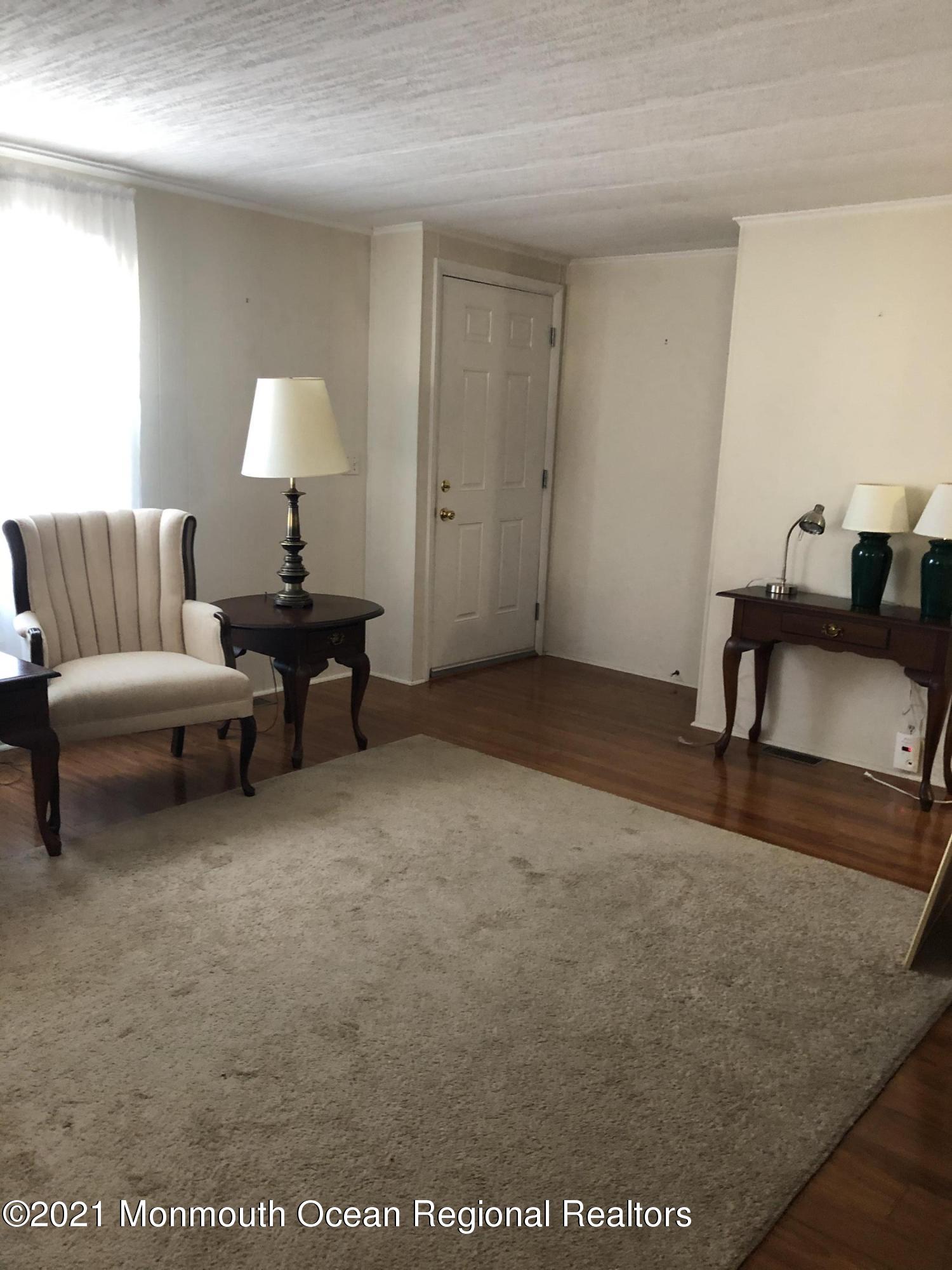 580 Cherin Road Freehold, NJ 07728 - Photo 5 of 23 a living room with furniture and a lamp