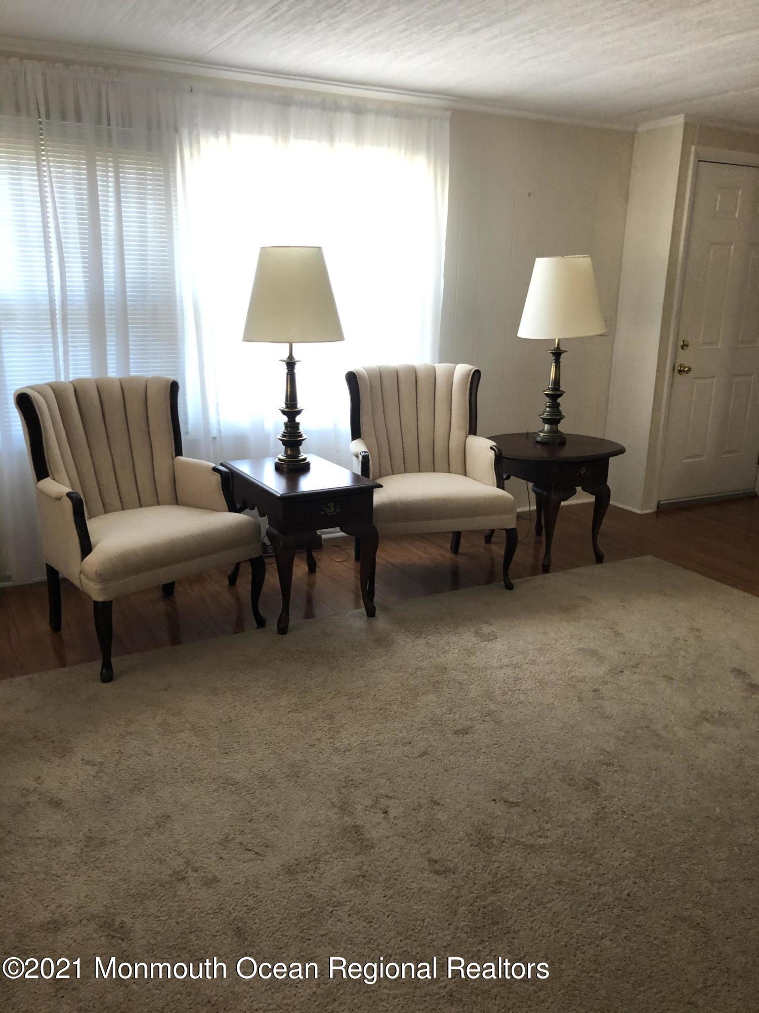 580 Cherin Road Freehold, NJ 07728 - Photo 6 of 23 a living room with furniture and a lamp