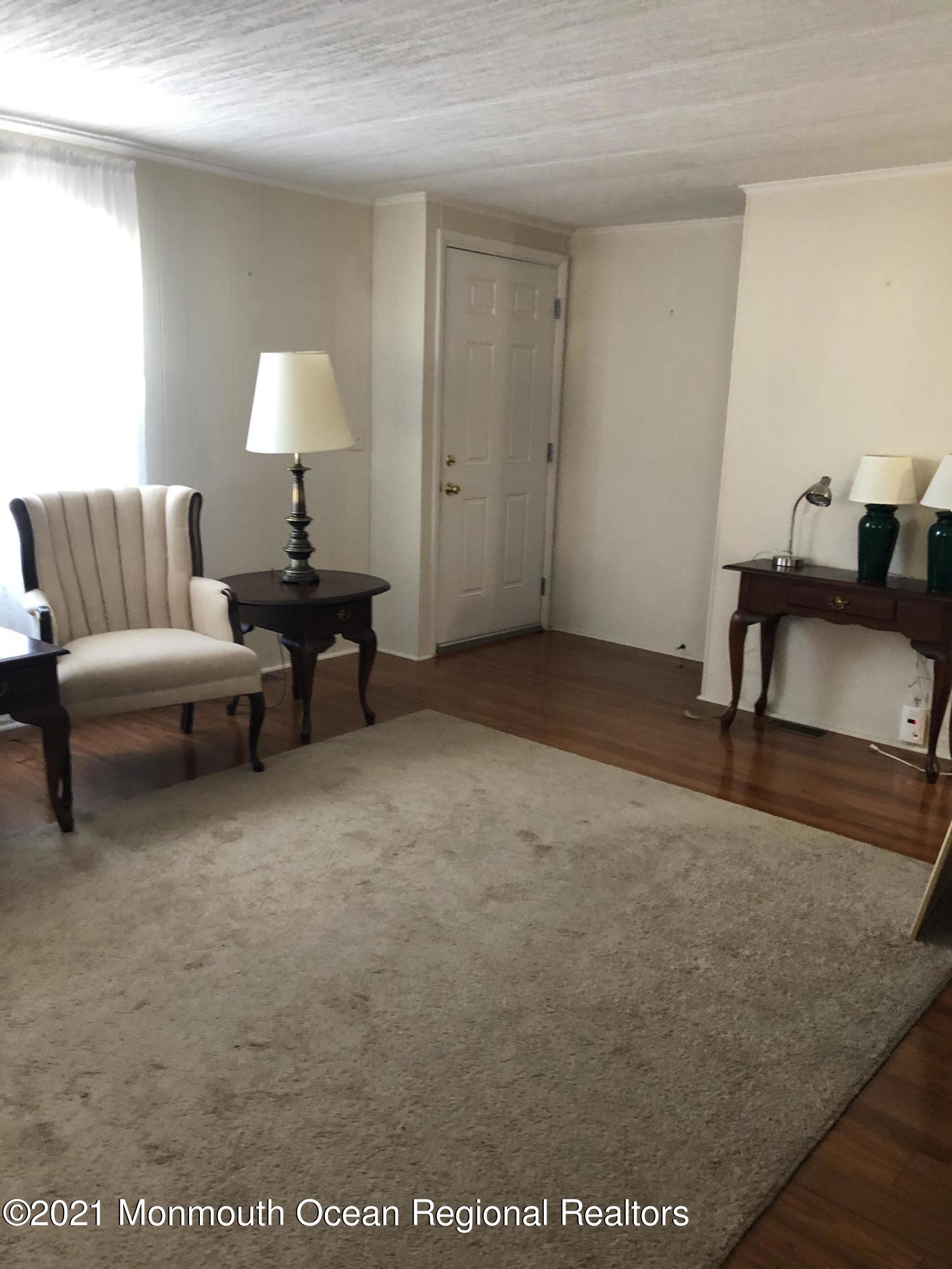 580 Cherin Road Freehold, NJ 07728 - Photo 7 of 23 a living room with furniture and a lamp