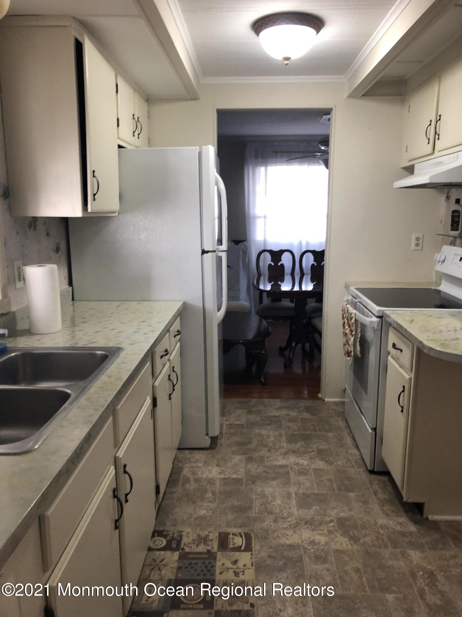 580 Cherin Road Freehold, NJ 07728 - Photo 9 of 23 a kitchen with a sink cabinets and stainless steel appliances