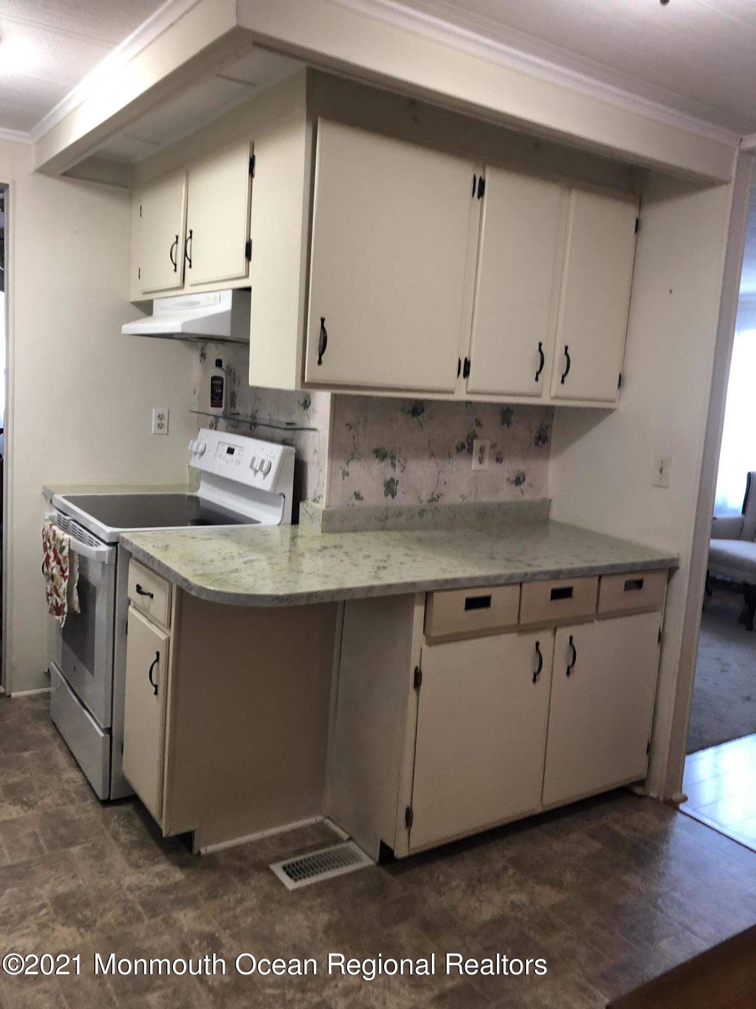 580 Cherin Road Freehold, NJ 07728 - Photo 10 of 23 a kitchen with stainless steel appliances granite countertop a sink stove and cabinets