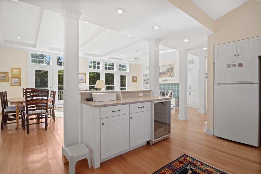 6 Chickadee Lane Truro, MA 02666 - Photo 13 of 42 a open kitchen with stainless steel appliances granite countertop a stove a sink a refrigerator and white cabinets with wooden floor