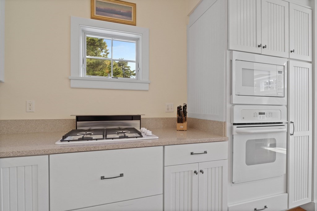 6 Chickadee Lane Truro, MA 02666 - Photo 15 of 42 a kitchen with white cabinets and appliances